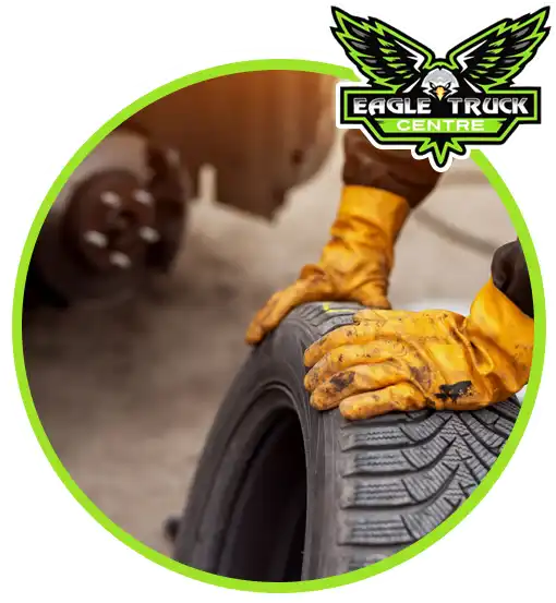 Eagle Truck Centre technician handling a truck tyre